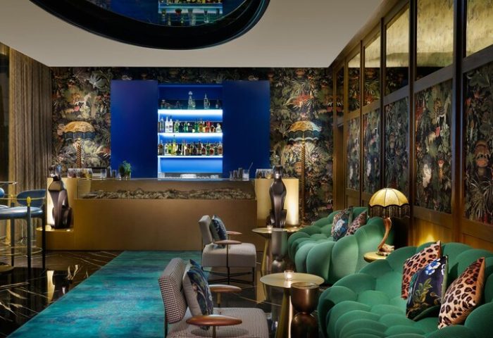 W Dubai - Mina Seyahi gay-friendly hotel bar. Stylish seating, jungle print wallpaper, and a well-stocked bar. A luxurious travel destination.