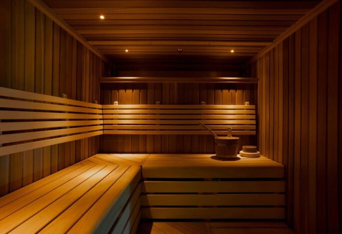 Sauna at St. Pancras Renaissance Hotel, London. Gay-friendly hotel with wooden benches, bucket, and ladle. Perfect for relaxation and wellness.