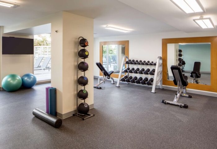 Hilton Garden Inn Waikiki Beach gay-friendly hotel gym. Dumbbells, exercise balls, and mats for a complete workout. Fitness on vacation.