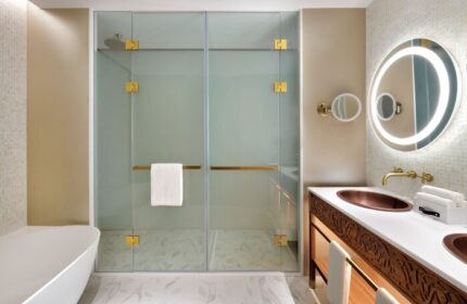 Hotel Indigo Dubai Downtown gay-friendly bathroom. Walk-in shower, copper sink, illuminated mirror. Upscale hotel for gay travelers.