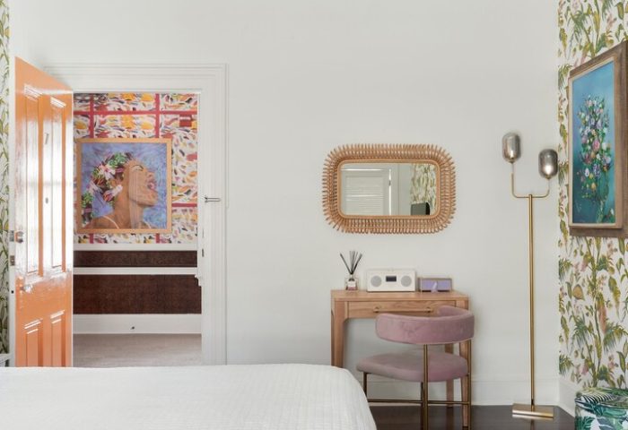 Marrero's Guest Mansion gay-friendly hotel room. Desk with mirror, chair, lamp, and art. Colorful wallpaper. Key West gay travel advice.