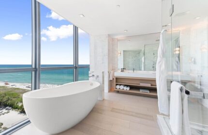 W South Beach gay-friendly hotel bathroom. Modern tub next to a large window with ocean view. Luxury gay travel at its finest.