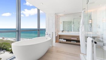 W South Beach gay-friendly hotel bathroom. Modern tub next to a large window with ocean view. Luxury gay travel at its finest.