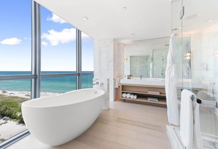 W South Beach gay-friendly hotel bathroom. Modern tub next to a large window with ocean view. Luxury gay travel at its finest.