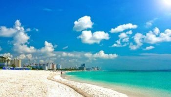 Strand Ocean Drive Suites: Gay-friendly hotel view of the beach and ocean. White sand, blue sky, and turquoise water. Perfect for gay travel.