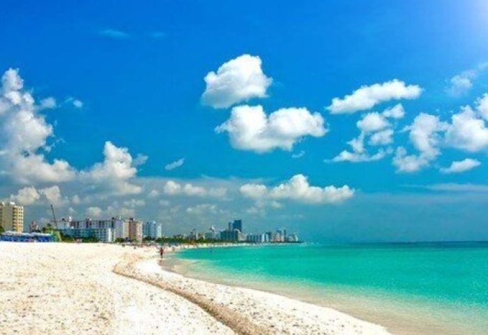 Strand Ocean Drive Suites: Gay-friendly hotel view of the beach and ocean. White sand, blue sky, and turquoise water. Perfect for gay travel.