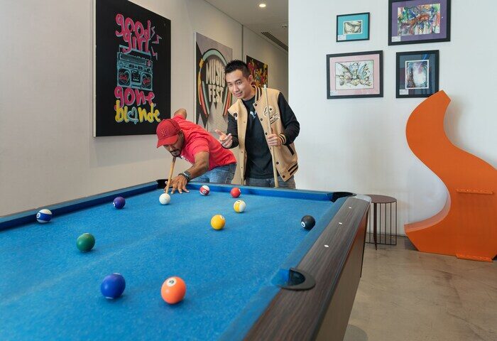 Aloft Me'aisam Dubai: Two men play pool at this gay-friendly hotel. The Aloft hotel offers a fun, inclusive atmosphere for gay travelers.