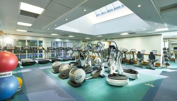 Crieff Hydro gay-friendly hotel gym. Treadmills, elliptical trainers, and exercise balls under a skylight. Fitness center for gay men's travel.
