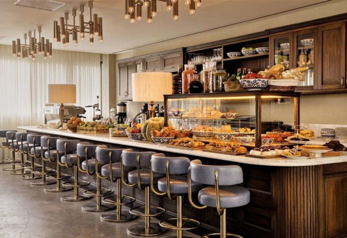 Soho House Istanbul's stylish bar area. A gay-friendly hotel with pastries, fruit, and comfortable seating. Perfect for gay men travel.
