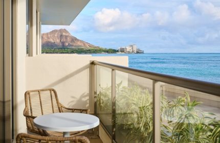 Outrigger Reef Waikiki Beach Resort balcony view. Diamond Head, ocean, table, & chairs. Gay-friendly hotel on Waikiki Beach, Hawaii.