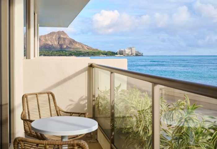 Outrigger Reef Waikiki Beach Resort balcony view. Diamond Head, ocean, table, & chairs. Gay-friendly hotel on Waikiki Beach, Hawaii.