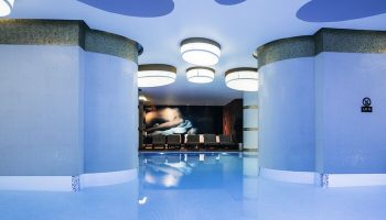 Indoor pool at The Elysium Taksim Hotel, a gay-friendly hotel. Relaxing spa area with lounge chairs. Perfect for gay travel in Istanbul.
