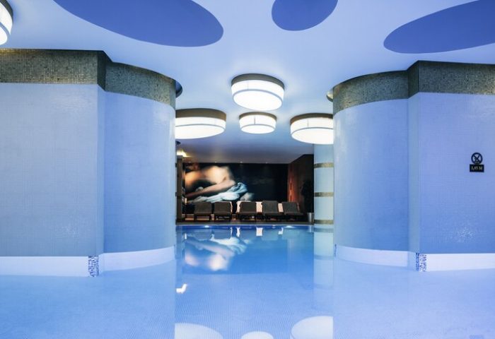 Indoor pool at The Elysium Taksim Hotel, a gay-friendly hotel. Relaxing spa area with lounge chairs. Perfect for gay travel in Istanbul.