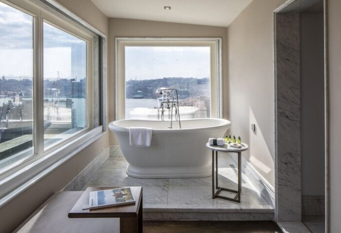 The Bank Hotel Istanbul bathroom. Gay-friendly hotel with a soaking tub, city view, and marble accents. Design Hotels™ Istanbul gay travel.