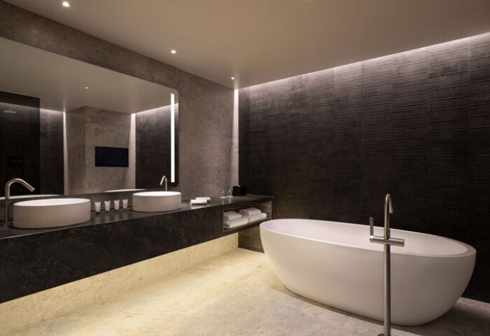 Bathroom at The Westin London City, a gay-friendly hotel. Features a modern tub, dual sinks, and sleek design, perfect for gay men's travel.