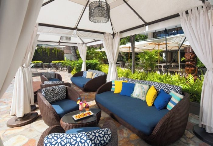 Sheraton Princess Kaiulani gay-friendly hotel outdoor lounge. Tropical resort seating area with couches, chairs, and cocktails. Gay travel.