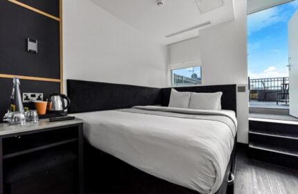 The Z Hotel Covent Garden: Gay-friendly hotel room with a double bed and balcony. Modern design, perfect for gay travelers. #GayTravel #London