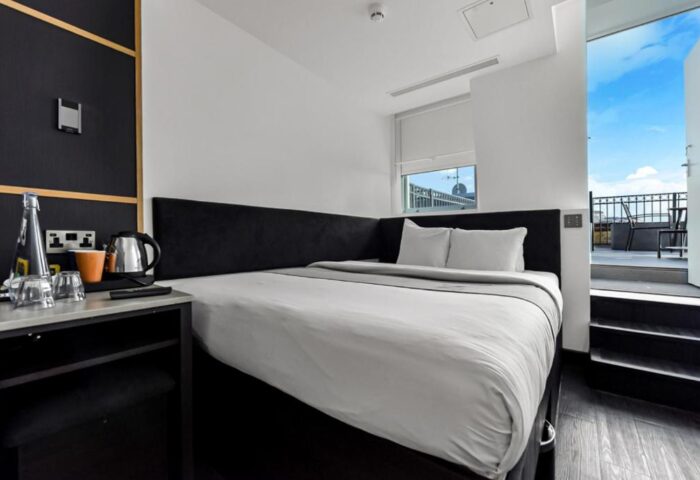 The Z Hotel Covent Garden: Gay-friendly hotel room with a double bed and balcony. Modern design, perfect for gay travelers. #GayTravel #London