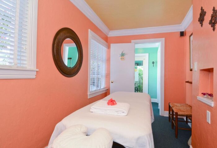 Gay-friendly Pineapple Point Guesthouse & Resort spa. Massage table in a room with peach walls. Gay men's travel destination.
