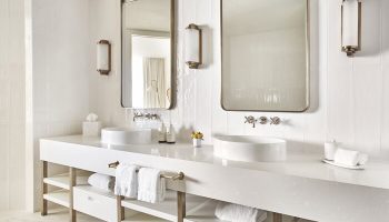 Four Seasons Hotel Fort Lauderdale: Modern, all-white bathroom with double sinks, large mirrors, and stylish fixtures. Gay-friendly hotel travel.