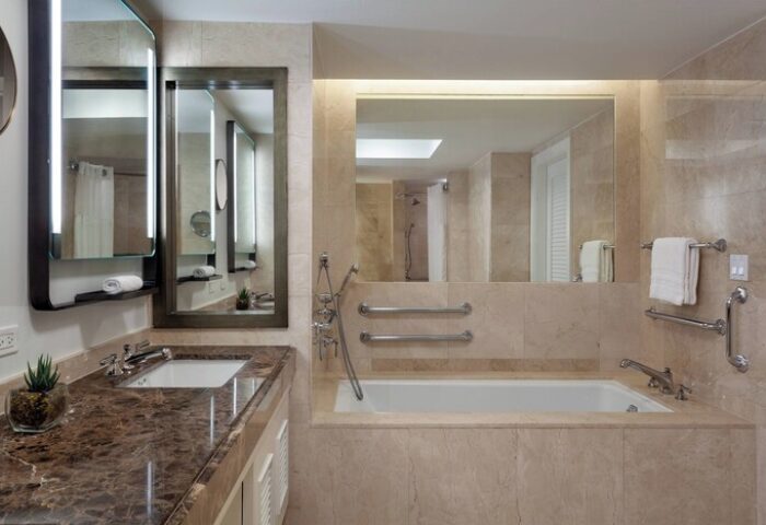 The Ritz-Carlton, Fort Lauderdale gay-friendly hotel bathroom. Marble vanity, mirrors, and bathtub. Accessible features for gay men travelers.