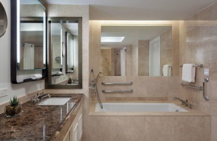 The Ritz-Carlton, Fort Lauderdale gay-friendly hotel bathroom. Marble vanity, mirrors, and bathtub. Accessible features for gay men travelers.
