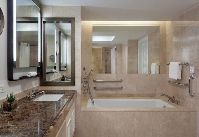 The Ritz-Carlton, Fort Lauderdale gay-friendly hotel bathroom. Marble vanity, mirrors, and bathtub. Accessible features for gay men travelers.
