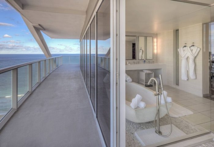 W Fort Lauderdale gay-friendly hotel suite. Balcony with ocean view, luxurious bathroom with soaking tub and robes. Perfect for gay travel.