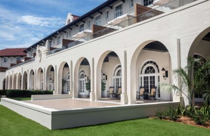 Casa Marina Key West, Curio Collection by Hilton, a gay-friendly hotel. Arches line the exterior of this luxury resort. Balconies visible.
