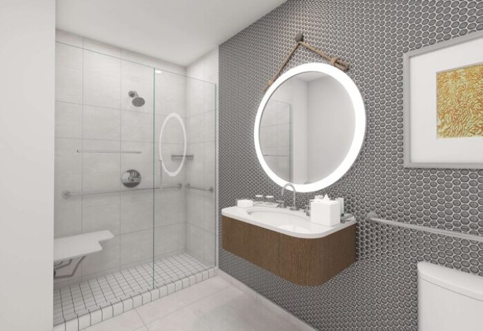 The Reach Key West, Curio Collection by Hilton gay-friendly hotel bathroom. Shower with seat, round mirror, and modern sink.