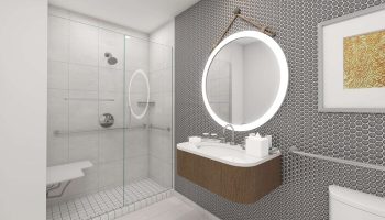The Reach Key West, Curio Collection by Hilton gay-friendly hotel bathroom. Shower with seat, round mirror, and modern sink.