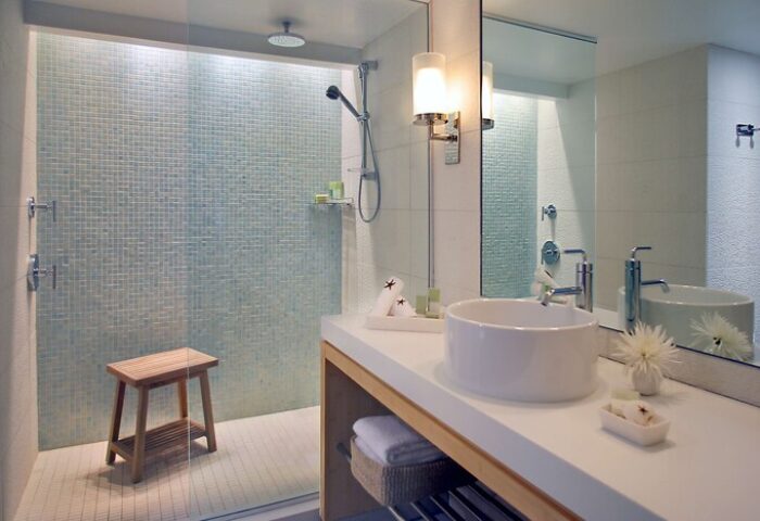 Hyatt Centric Key West Resort bathroom. Walk-in shower with blue mosaic tile. Modern sink and vanity. Gay-friendly hotel bathroom.