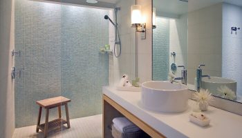 Hyatt Centric Key West Resort bathroom. Walk-in shower with blue mosaic tile. Modern sink and vanity. Gay-friendly hotel bathroom.