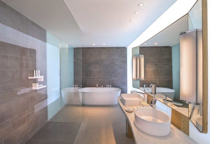 Bathroom at Nikki Beach Resort & Spa Dubai, a gay-friendly hotel. Features a modern bathtub, double sinks, and sleek design. Perfect for gay travel.