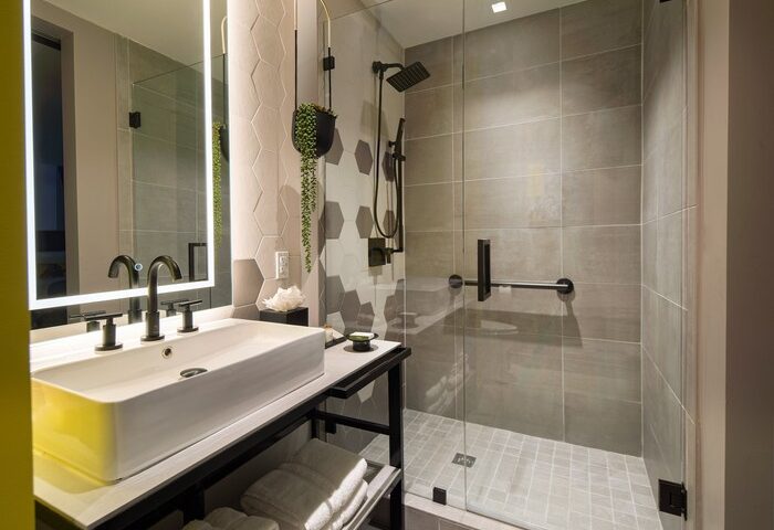 Hotel Indigo Miami Brickell bathroom. Modern design with walk-in shower, sleek sink, and hexagonal tile. Gay-friendly hotel for the discerning traveler.