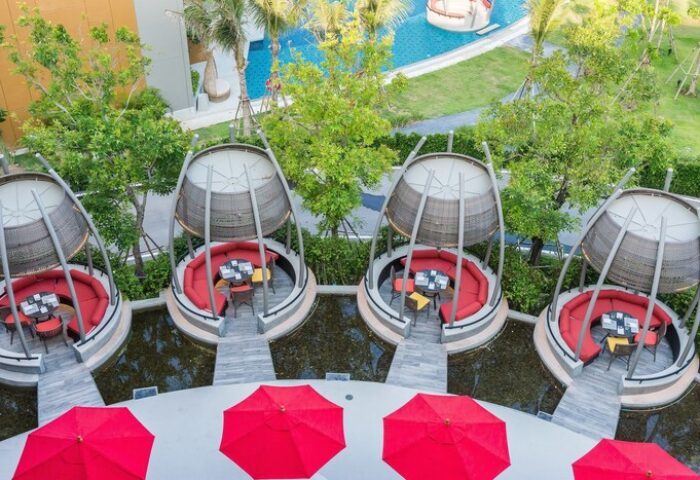 Avani+ Hua Hin Resort's unique dining pods. This gay-friendly hotel offers luxurious outdoor seating, ideal for gay men's travel.