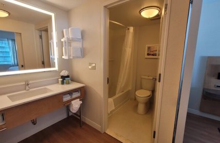 Hampton Inn & Suites Miami/Brickell-Downtown gay-friendly hotel bathroom. Sink, mirror, toilet, and shower in a modern room.