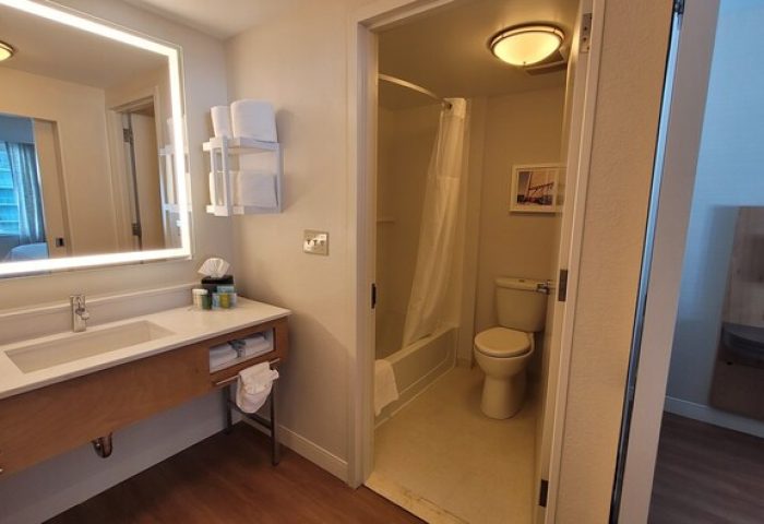 Hampton Inn & Suites Miami/Brickell-Downtown gay-friendly hotel bathroom. Sink, mirror, toilet, and shower in a modern room.