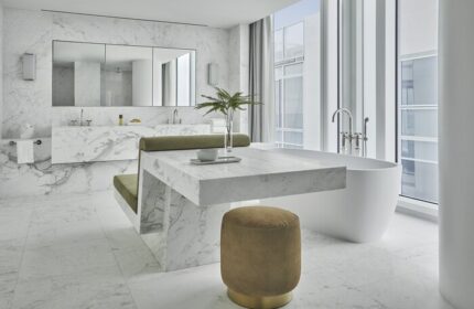 Four Seasons Hotel at The Surf Club bathroom. Gay-friendly hotel features marble accents, a soaking tub, and luxurious design. Stylish, modern.