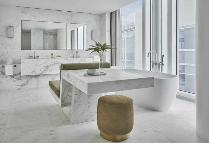 Four Seasons Hotel at The Surf Club bathroom. Gay-friendly hotel features marble accents, a soaking tub, and luxurious design. Stylish, modern.