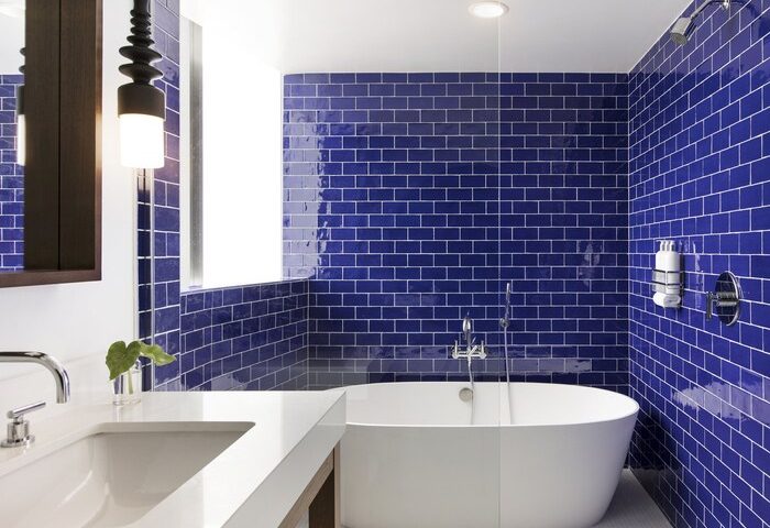 Kimpton Angler's Hotel bathroom. Blue tiled walls, white tub and sink. Gay-friendly hotel with modern design. Perfect for gay travel.