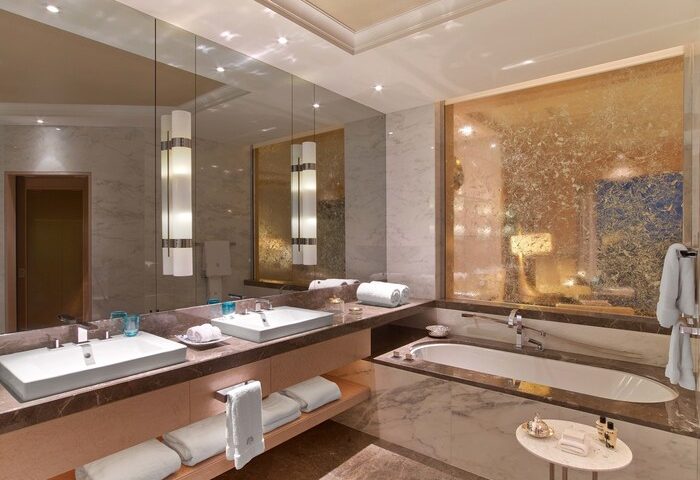 Raffles Istanbul Hotel bathroom. Luxurious, gay-friendly hotel with double sinks, marble, and a bathtub. Perfect for gay travel and relaxation.
