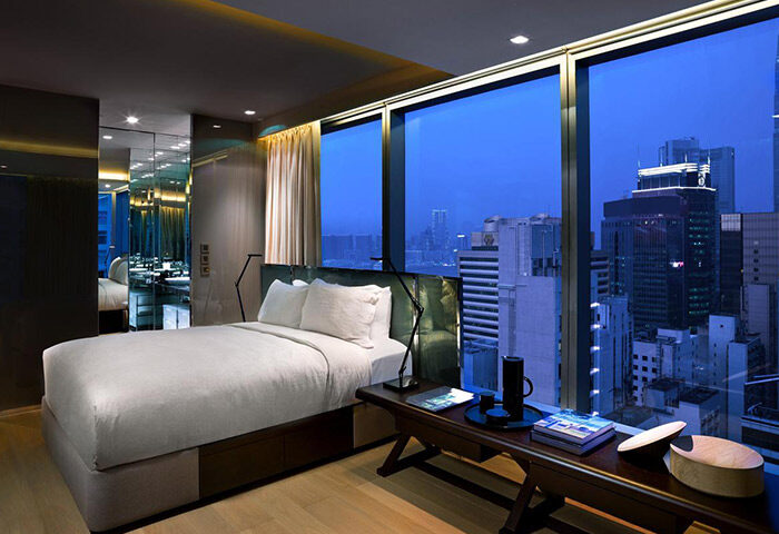 99 Bonham gay-friendly hotel room with city view. Modern design, large windows, bed, and stylish decor. Ideal for gay travelers seeking luxury.