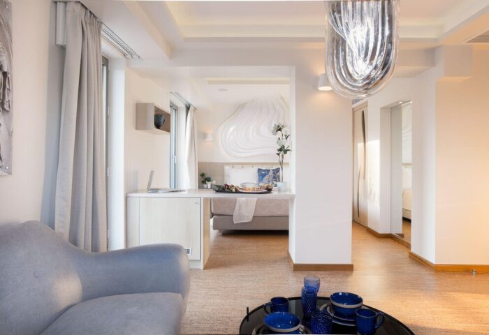 A For Athens Hotel's gay-friendly room. Modern design with a bed, desk, and sitting area. Perfect for gay men traveling to Athens.