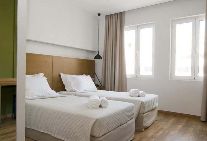 A For Athens Hotel twin room. Gay-friendly hotel with two beds, white linens, and minimalist decor. Ideal for gay travelers in Athens, Greece.