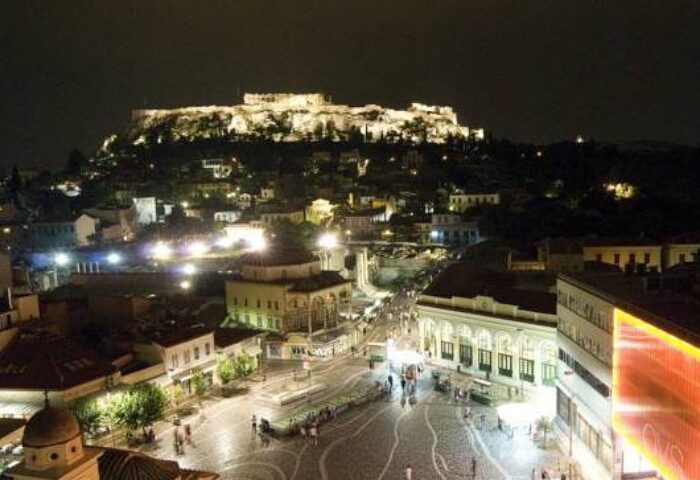 Night view from A For Athens Hotel, a gay-friendly hotel. The Acropolis is lit up in the background, overlooking the city.