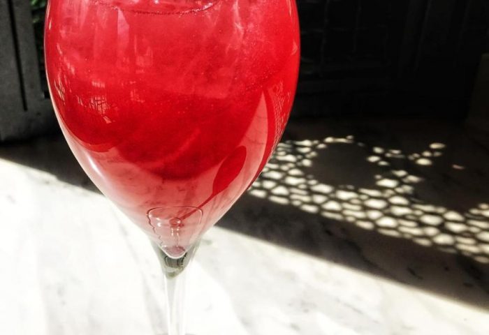 A For Athens Hotel's cocktail. Red drink with flower garnish. Gay-friendly hotel bar. Athens travel advice. Refreshing cocktail.