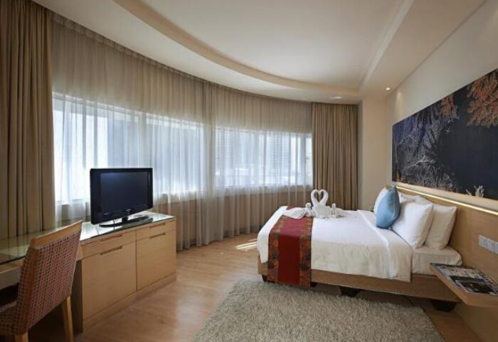 ANSA Hotel Kuala Lumpur room. Gay-friendly hotel with bed, TV, desk, and swan towels. Modern design, good for gay travel in Kuala Lumpur.
