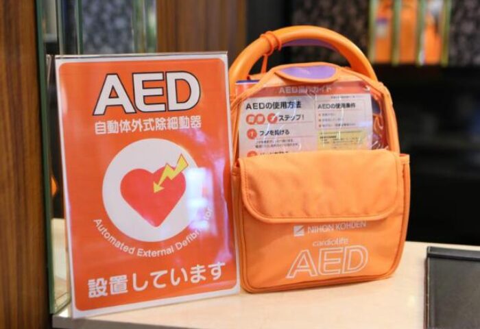 AED sign and AED bag at APA Hotel Shinjuku-Gyoemmae, a gay-friendly hotel. Automated external defibrillator for guest safety.