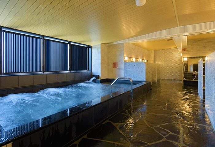 APA Hotel Shinjuku-Kabukicho Tower's onsen. This gay-friendly hotel offers a relaxing spa experience with its traditional Japanese hot spring bath.